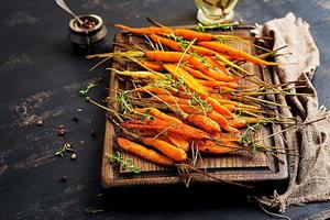 Baked organic carrots with thyme, honey and lemon. Organic vegan food.