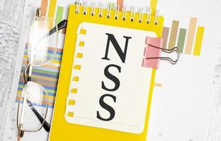 Notebook with text NSS Network Security Services on a chart background photo