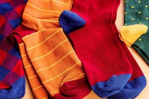 Socks of different colors on a beige background. Brown green red socks macro photo. photo