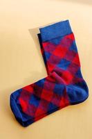 A pair of socks. Red and blue checkered socks on a beige background. photo