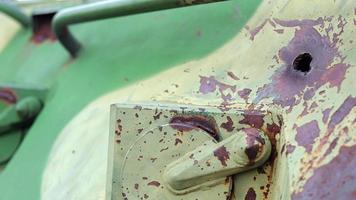 War in Ukraine, a hole in the armor of an infantry fighting vehicle, armor pierced. Texture of green camouflage armored metal with damage and holes. Destroyed military armored personnel carrier. video