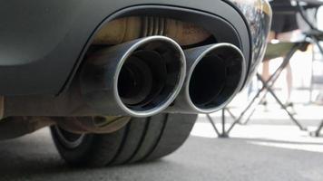 Bottom view of the exhaust system of a new luxury car. Panoramic view. Close-up of a dual exhaust pipe to remove harmful substances from engine exhaust and reduce vehicle noise. video