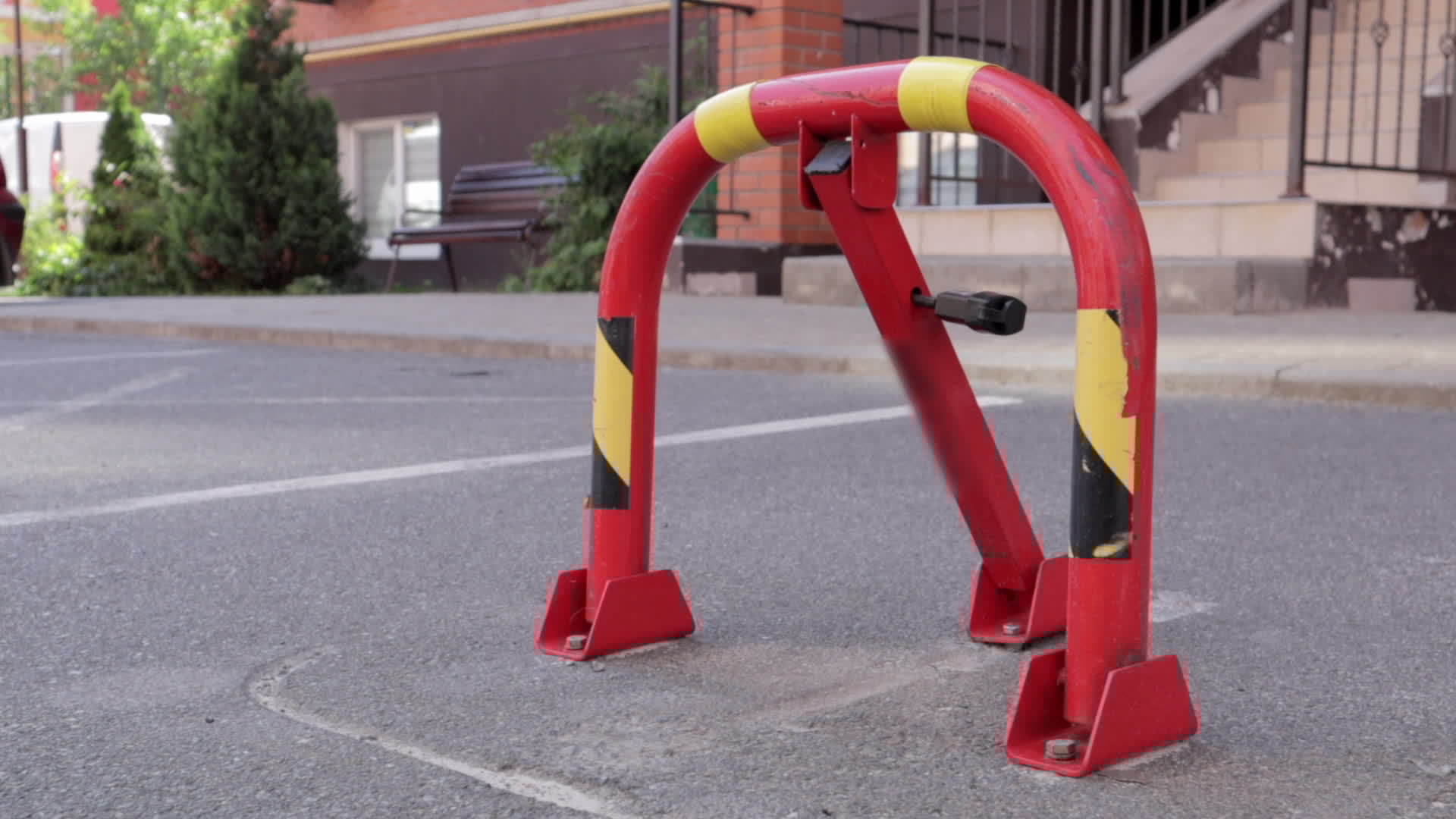 One red parking lock. Closeup video. Reserved car parking space