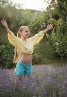 Beautiful little girl in a field with lavender. photo