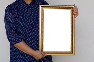 Closeup woman holds empty photo frame or blank diploma certificate frame. Copy space for adding text or photos.  Concept, Proud, memories and nostalgia .