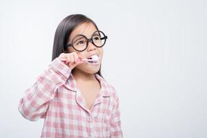 little girl Asia brushing teeth happily white background photo