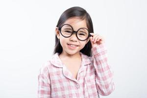 little girl asian wearing glasses, pink shirt, white background photo