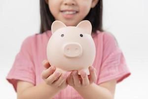 girl hands hold a pink piggy bank . The concept of saving money or savings, investment photo