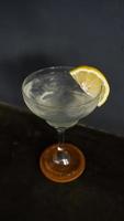 Lemonade. refreshing sparkling drink in an elegant glass garnished with a lemon wedge photo