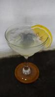 Lemonade. refreshing sparkling drink in an elegant glass garnished with a lemon wedge photo