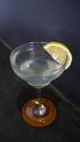 Lemonade. refreshing sparkling drink in an elegant glass garnished with a lemon wedge photo