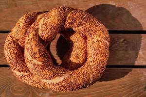 stack of freshly baked Turkish bagel simit. Wooden background. View from above. photo