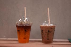 Black coffee with orange juice and iced mocha on wooden table photo