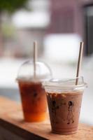 Black coffee with orange juice and iced mocha on wooden table photo