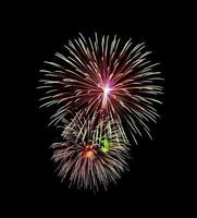 Beautiful colorful fireworks exploding in the night sky, isolated on black background photo