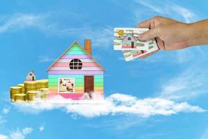 Start creating family with home and coin on white cloud and blue sky background,Dream family concepts photo