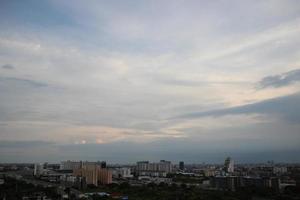 dark storm cloudy sky in rainy day with city building background photo