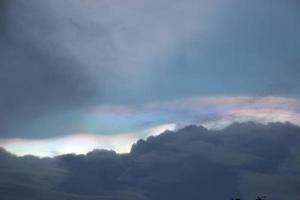 rainbow light behind the dark clouds sky backgrounds photo