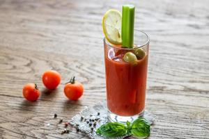 Bloody Mary cocktail on the wooden background photo