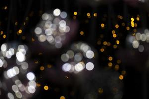 abstract bokeh blur light orange and white glowing flare pattern black background photo