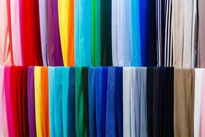 primer plano de coloridas bufandas colgadas en el mercado. foto