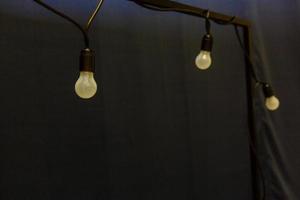 Light bulbs on dark blue background photo