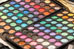 Make-up colorful eyeshadow palettes isolated on black background photo