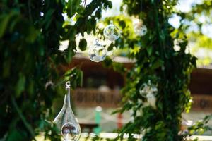 Original wedding floral decoration in the form of mini-vases and bouquets of flowers hanging from the ceiling photo