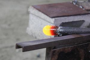 The master works with glass at a glass factory. photo