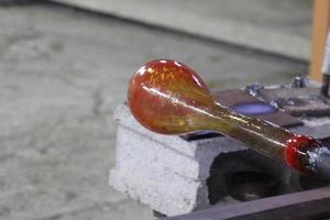 The master works with glass at a glass factory. photo