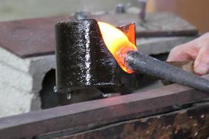 The master works with glass at a glass factory. photo