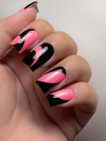 The fashionable color of 2023 is Viva Magenta. Fashionable manicure design. Women's hands with a beautiful manicure. Close-up, selective focusing photo