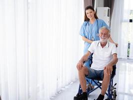 Female woman lady girl person doctor nurse staff assistant health care treatment wheel chair olderly man people handicap nursing home white isolated background copy space caregiver indoor hospital photo