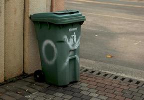 Jakarta, Indonesia - January 21th, 2023 - Krisbow green large outdoor trash bin in outdoor space environment. Public road trash can. photo