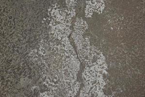 Cracks on public road. Damaged old concrete stone outdoor. photo