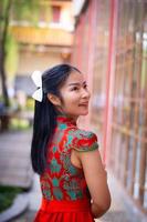 Smart girl in red  color dress style chiness new year in culture and public chiness temple background photo