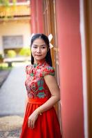 Smart girl in red  color dress style chiness new year in culture and public chiness temple background photo