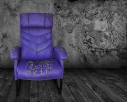 Old purple chair in a dark room photo