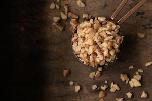 Chopped Walnuts Spilled from a Teaspoon photo