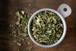 Dry Celery Flakes in a Measuring Cup photo