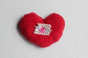 Hand made red heart close up on light background with red ribbon, Valentine day postcard,holiday wallpaper,cover design,needlework hobby,kids hands with heart symbol,copy space photo