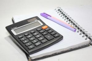 Black digital calculator isolated on the top view white background photo