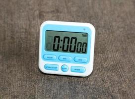 Digital Kitchen timer white color and light blue color on dark background photo