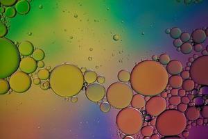 multi colored oil circles on the water, colorful background photo