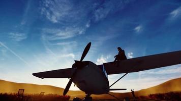 silhouette woman sitting on plane wing and a boy running with toy plane,3D Animation. video