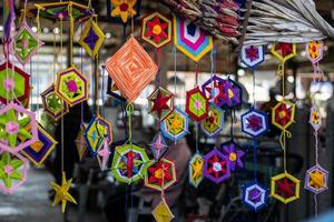 A collection of hand-knitted mobile phone cases in squares of various colors, beautifully hung. photo