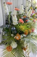 Close-up view of rows of white bouquets, roses and chrysanthemums of various colors. photo
