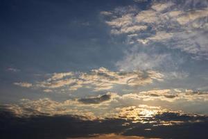 Scenery against a cloudy background with yellow sunlight passing through the blue sky. photo
