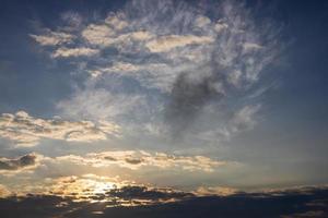 Scenery against a cloudy background with yellow sunlight passing through the blue sky. photo