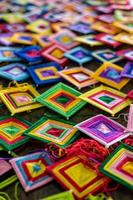 Mobile background with hand-knotted yarn in squares of various colors arranged on the floor. photo